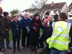 Deirdre Wadding speaks with the workers installing the water meters.