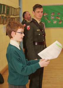 Stuart Ó Rosaitéar reads a section of the Constitution as Lt. Shane Foood looks on at the 1916 flag presentation in the Wexford Gaelscoil. Pic: Christy Farrell