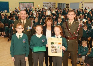 Pictured at the 1916 flag presentation ceremony in the Wexford Gaelscoil are Stuart Ó Rosaitéar, Sgt. Kiaran Flood. Isla agus Amy Ní Ruagain Ní Cheallaigh, Aine Ui Ghionnain (Principal) and Lt. Shane Flood. Pic: Christy Farrell