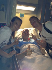 Ian pictured in his hospital bed surrounded by friends