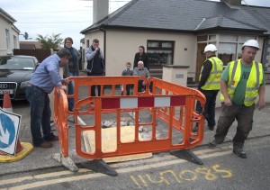 Water meter installers walk away as our photographer took a photo during a disagreement with members of Carley family in Davitt Road. Pic: Jim Campbell
