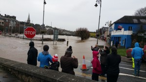 People look on at the devastation caused by the floods in Enniscorthy.