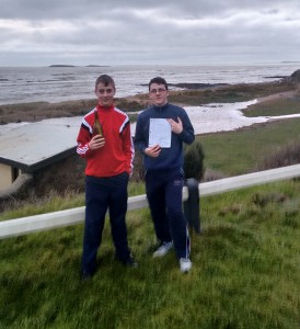 Cian and Tiarnan O’Grady pictured with the bottle and message they discovered washed in on the beach at Cullenstown