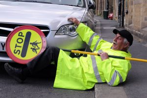 Comedian Robert Webb as a lollipop man